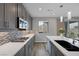 Well-lit kitchen featuring gray cabinetry, stainless steel appliances, and quartz countertops at 9876 Heather Moore Ave, Las Vegas, NV 89166