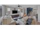 Open-concept living room featuring stairs, modern TV, and comfortable seating at 9876 Heather Moore Ave, Las Vegas, NV 89166