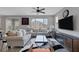 Inviting living room featuring a ceiling fan, a large window, and stylish, comfortable seating at 9876 Heather Moore Ave, Las Vegas, NV 89166