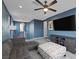 Comfortable living room features a gray sofa, ceiling fan, and large television for entertainment at 9876 Heather Moore Ave, Las Vegas, NV 89166
