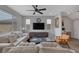 Bright living room with a ceiling fan, large TV, and stylish decor for relaxation and entertainment at 9876 Heather Moore Ave, Las Vegas, NV 89166
