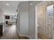 Hallway view leading to a powder room featuring unique wall tiles and modern fixtures at 9876 Heather Moore Ave, Las Vegas, NV 89166