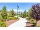 Scenic community walking path lined with trees, providing a serene environment for residents at 9876 Heather Moore Ave, Las Vegas, NV 89166