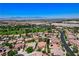 Broad aerial view of a neighborhood featuring mature trees, landscaping, golf course, and a distant mountain backdrop at , North Las Vegas, NV 89084