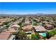 Expansive aerial view of a neighborhood with pools, mature landscaping, and picturesque mountain views at , North Las Vegas, NV 89084