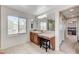 Bright bathroom with soaking tub, walk-in shower, vanity and a large mirror at , North Las Vegas, NV 89084
