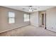 Spacious bedroom featuring neutral paint, carpet floors, a ceiling fan and two windows at , North Las Vegas, NV 89084