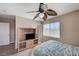 Neutral bedroom design with a full bed, TV on cabinet, ceiling fan and natural lighting at , North Las Vegas, NV 89084