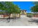 Two-story home featuring a two-car garage, desert landscaping, and mature shade trees at , North Las Vegas, NV 89084