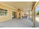 Wide, covered patio with dual ceiling fans and multiple seating areas at , North Las Vegas, NV 89084