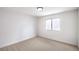 A bright bedroom features neutral carpet, white walls, and a window at 10009 Coral Sands Dr, Las Vegas, NV 89117