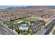 Expansive aerial view of the community featuring a pool, park, and surrounding houses at 10116 Skye Castle Dr, Las Vegas, NV 89166