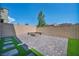 Backyard featuring brick pavers, artificial turf, firepit, and privacy walls at 10116 Skye Castle Dr, Las Vegas, NV 89166