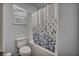Bright bathroom featuring a shower-tub combination with a patterned shower curtain and a window at 10116 Skye Castle Dr, Las Vegas, NV 89166