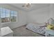Bedroom with a cozy bed, window, neutral walls, and carpet flooring at 10116 Skye Castle Dr, Las Vegas, NV 89166