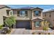 Two-story home boasts a neutral color palette, stone accents, and a two-car garage with an attractive brick paver driveway at 10116 Skye Castle Dr, Las Vegas, NV 89166