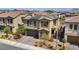 Attractive home featuring a two-car garage, manicured landscaping, and a welcoming entryway at 10116 Skye Castle Dr, Las Vegas, NV 89166
