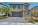 Two-story home boasts a neutral color palette, stone accents, and a two-car garage with an attractive brick paver driveway at 10116 Skye Castle Dr, Las Vegas, NV 89166