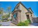 Side view of home boasts a neutral color palette and stone accents with an attractive brick paver walkway and lush landscaping at 10116 Skye Castle Dr, Las Vegas, NV 89166