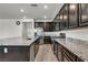 Modern kitchen features stainless steel appliances, granite countertops, and dark cabinets at 10116 Skye Castle Dr, Las Vegas, NV 89166