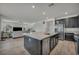 Open concept kitchen with a large island, stainless steel appliances, and dark wood cabinets at 10116 Skye Castle Dr, Las Vegas, NV 89166