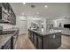 Open kitchen featuring stainless steel appliances and a large island that leads to the living room at 10116 Skye Castle Dr, Las Vegas, NV 89166