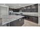 The spacious kitchen with dark cabinets and granite countertops at 10116 Skye Castle Dr, Las Vegas, NV 89166