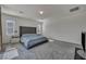 Spacious main bedroom with carpet floors, natural light, and a comfortable bed at 10116 Skye Castle Dr, Las Vegas, NV 89166