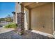 Covered porch features stone columns and brick pavers, offering a welcoming entrance to the home at 10116 Skye Castle Dr, Las Vegas, NV 89166