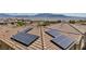 View of solar panels affixed to a terracotta tiled roof in a residential community at 10116 Skye Castle Dr, Las Vegas, NV 89166