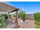 Covered patio and backyard with desert landscaping and rock features at 1017 Pebble Lake St, Henderson, NV 89011