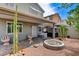 Inviting backyard featuring a covered patio, fire pit, and unique decorative elements, perfect for outdoor entertaining at 1017 Pebble Lake St, Henderson, NV 89011