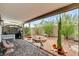 Covered patio with a desert-landscaped backyard, rock features, and a built-in grill at 1017 Pebble Lake St, Henderson, NV 89011