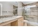 Bright bathroom features single sink with granite counters, and shower with glass door at 1017 Pebble Lake St, Henderson, NV 89011