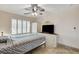 This bedroom features a ceiling fan, shutters, and a dresser with mounted television at 1017 Pebble Lake St, Henderson, NV 89011