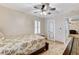 This bedroom features a ceiling fan, shutters, and a doorway to the hallway at 1017 Pebble Lake St, Henderson, NV 89011