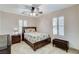 This bedroom features a ceiling fan, shutters, and a nightstand at 1017 Pebble Lake St, Henderson, NV 89011