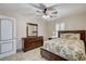 This bedroom features a ceiling fan, shutters, and a dresser at 1017 Pebble Lake St, Henderson, NV 89011