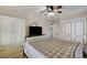 This bedroom features a ceiling fan, shutters, and a closet at 1017 Pebble Lake St, Henderson, NV 89011