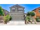 Charming two-story home with a well-maintained exterior, two-car garage, desert landscaping, and modern architectural details at 1017 Pebble Lake St, Henderson, NV 89011