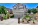 Inviting home showcasing a two-car garage and desert landscaping at 1017 Pebble Lake St, Henderson, NV 89011