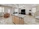 Open concept kitchen with island seating, stainless steel appliances, and dining area at 1017 Pebble Lake St, Henderson, NV 89011