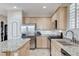 Bright kitchen with an island, stainless steel appliances and light wood cabinets at 1017 Pebble Lake St, Henderson, NV 89011