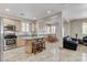 Bright, open kitchen with stainless appliances and island seating flows into living area at 1017 Pebble Lake St, Henderson, NV 89011