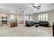 Open concept living room and kitchen with tile flooring and natural light at 1017 Pebble Lake St, Henderson, NV 89011