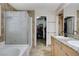 Main bathroom showcasing double sinks, a soaking tub, and a walk-in shower at 1017 Pebble Lake St, Henderson, NV 89011