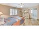 Comfortable main bedroom featuring tile flooring, ceiling fan, and plenty of natural light at 1017 Pebble Lake St, Henderson, NV 89011