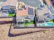 Aerial shot of a modern home with solar panels, a jacuzzi, and manicured green space at 1038 Delbrook Ave, Henderson, NV 89012