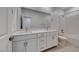 Modern bathroom featuring a double vanity, a large mirror, and a shower-tub combination at 1038 Delbrook Ave, Henderson, NV 89012