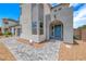 Close-up of a modern home's front entrance with a striking blue door and desert landscaping at 1038 Delbrook Ave, Henderson, NV 89012